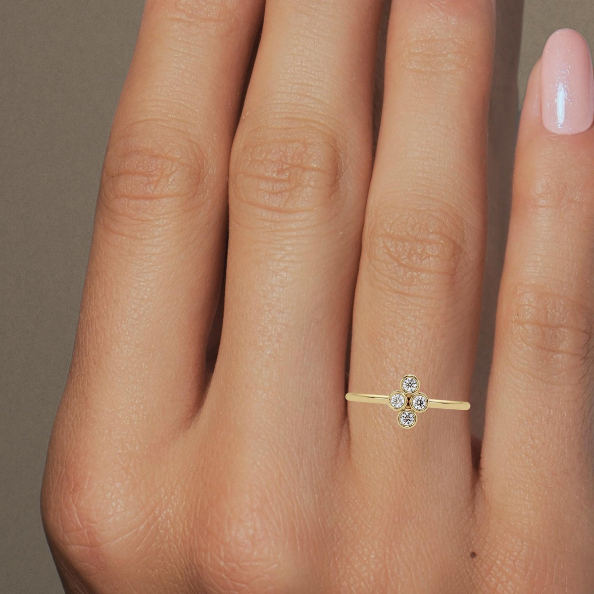 14k yellow gold four stone diamond ring with bezel set natural diamonds.