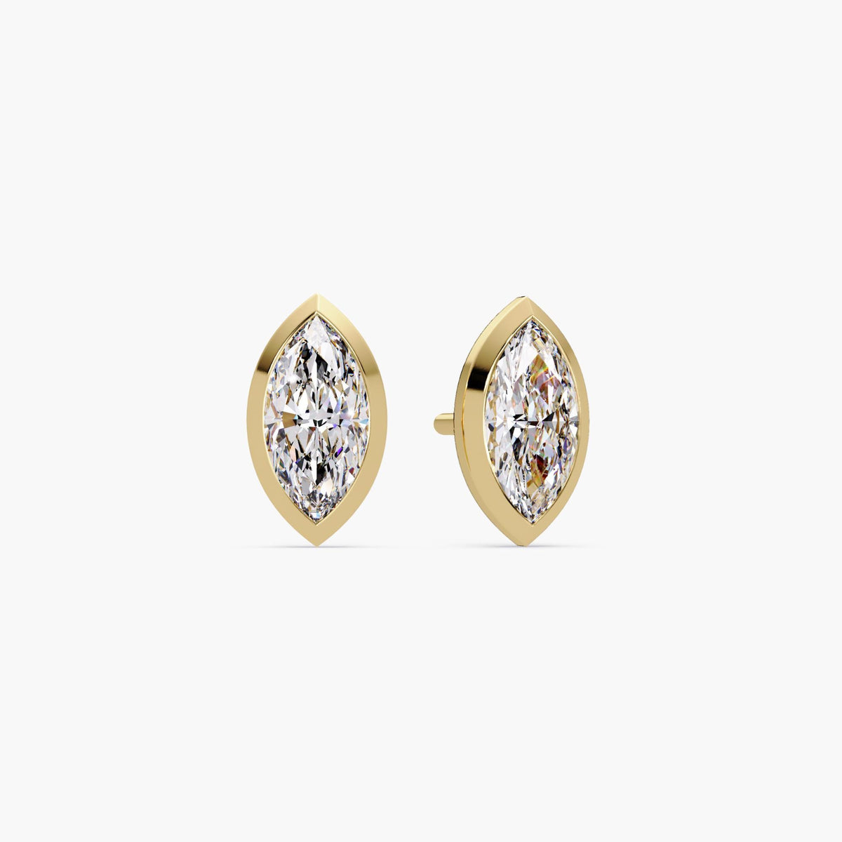 A pair of marquise cut lab grown diamond stud earrings set in 14k yellow gold bezel settings. The diamonds have pointed tips and a brilliant elongated shape. These minimalist earrings are secured with pushback posts, perfect for everyday wear, weddings, or gifting.