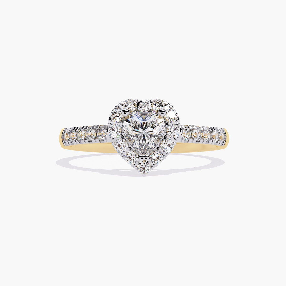 A heart-shaped diamond engagement ring with a halo setting and a gold band. there are pave diamonds on the shank.
