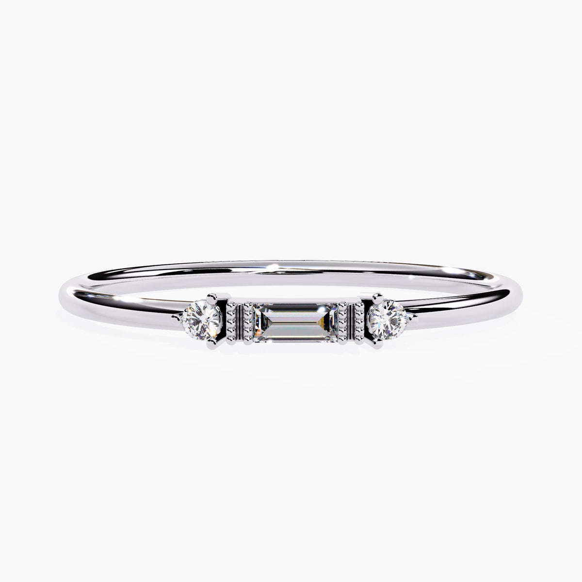 Front view of a 14K white gold ring featuring a baguette-cut natural diamond flanked by two round diamonds. A minimalist stacking ring perfect for anniversaries or daily wear.