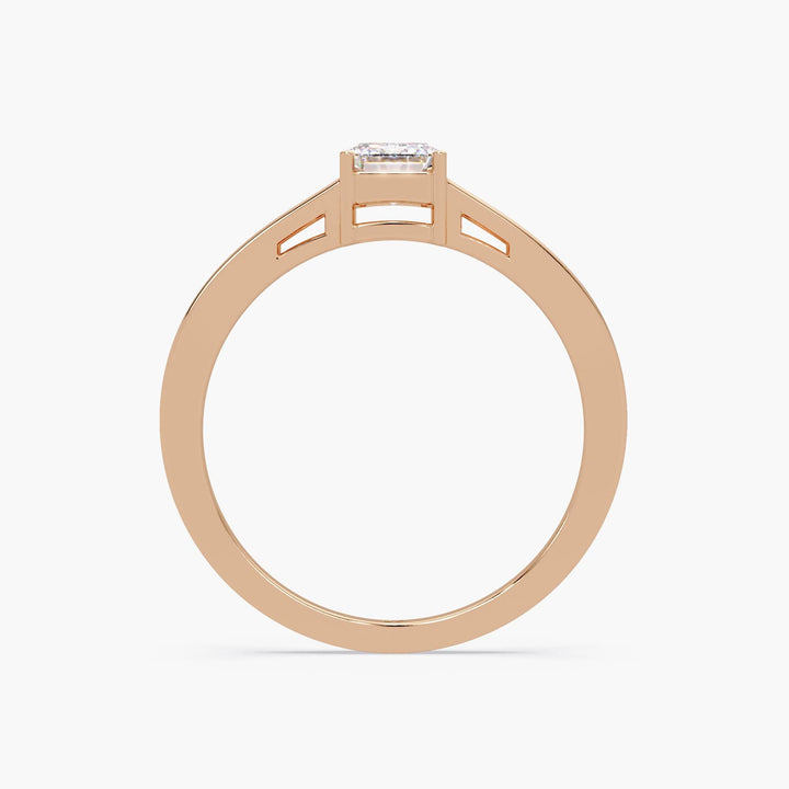 Minimalist rose gold diamond ring showcasing a rectangular emerald-cut stone.