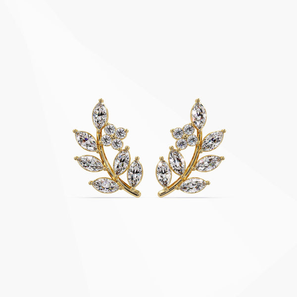Pair of 14k yellow gold leaf earrings displayed on a white background highlighting the elegant branch shape.