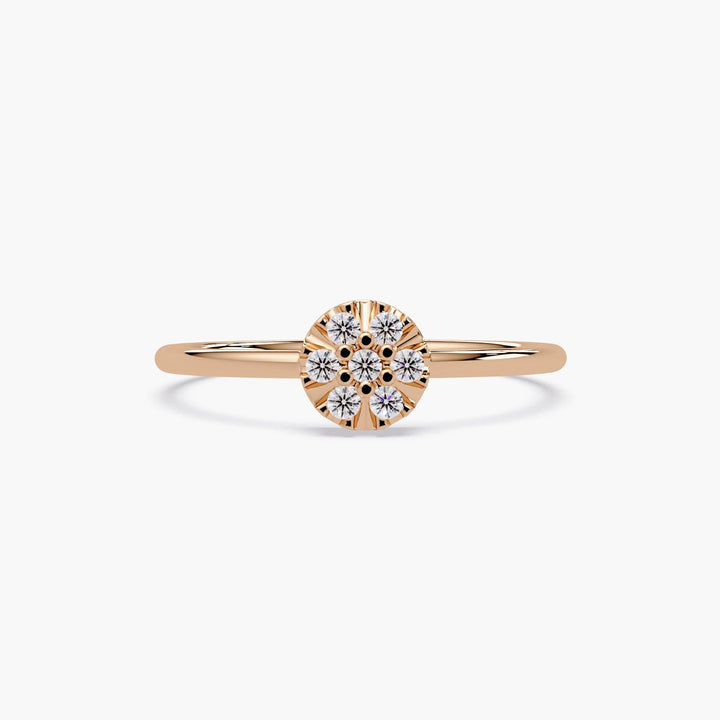 Elegant stacking ring in 14k gold with a flower-shaped diamond cluster.
