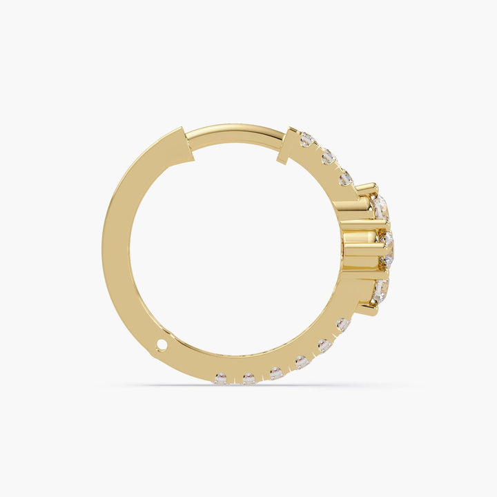 14K yellow gold hoop earrings on a white background, featuring a floral or clover-shaped cluster of lab-grown diamonds at the front.