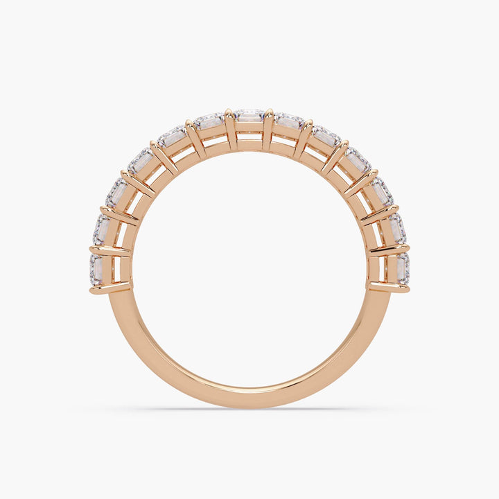 Elegant gold anniversary band with emerald diamonds.