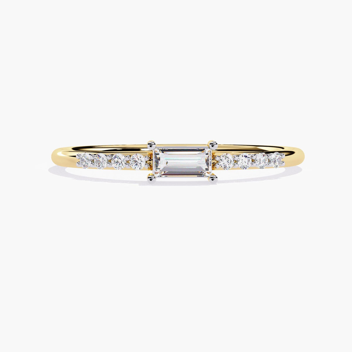 A thin yellow gold band with a small rectangular diamond in the center and smaller round diamonds on either side of the center stone.