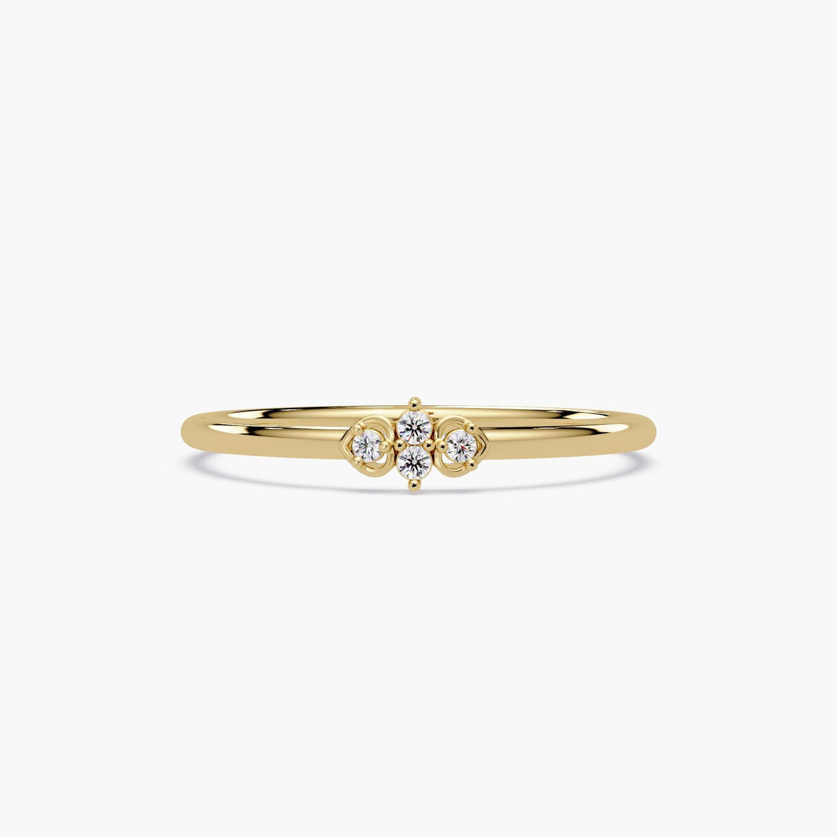 A 14k gold heart-inspired diamond ring with four prong set stones.