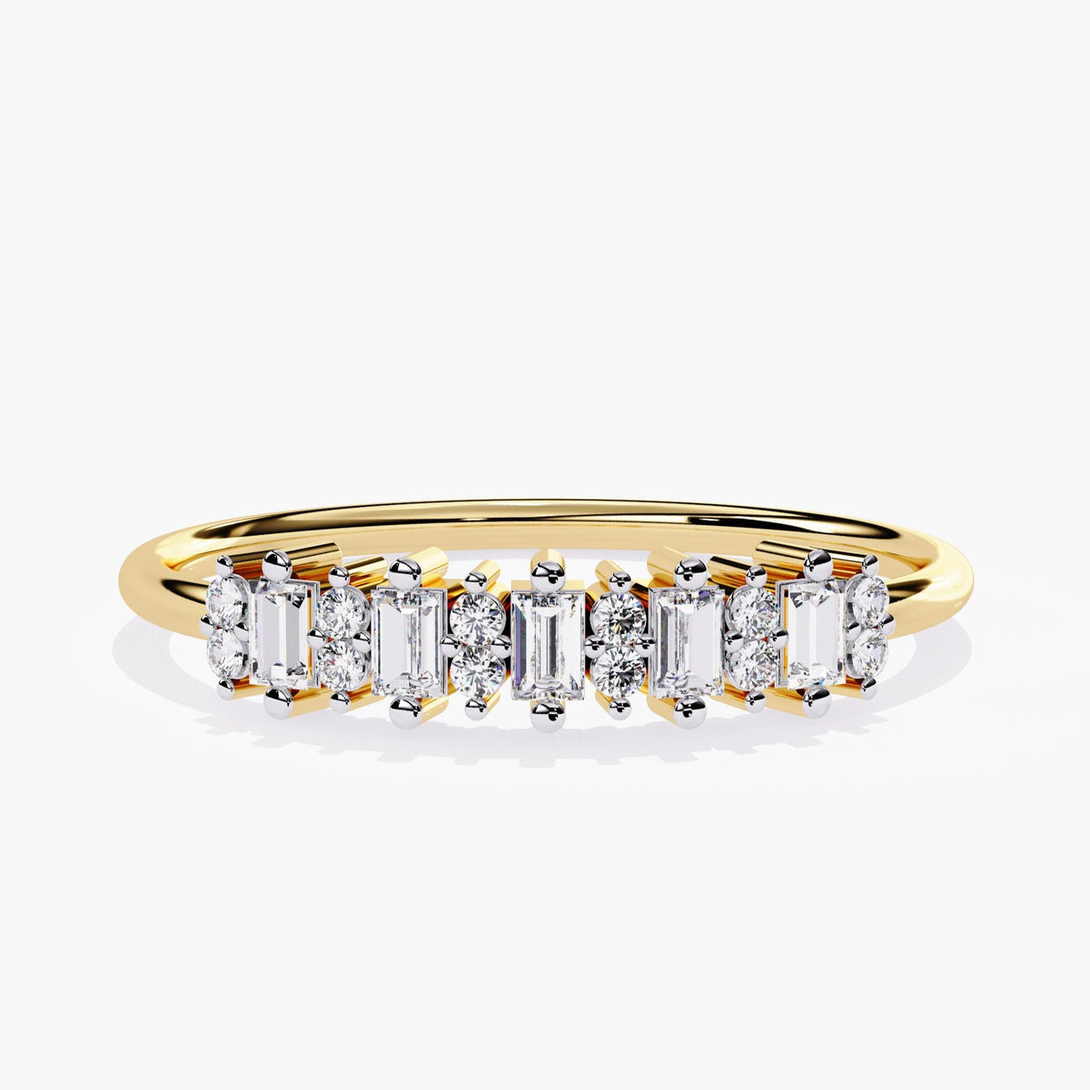 Front view of a 14k yellow gold ring featuring alternating vertical baguette and round diamonds in a half eternity design. A versatile stacking band that pairs well with other dainty rings or worn solo for subtle brilliance. Suitable as a modern wedding band, anniversary gift, or everyday fine jewelry. The alternating pattern adds brilliance and structure to a timeless silhouette.