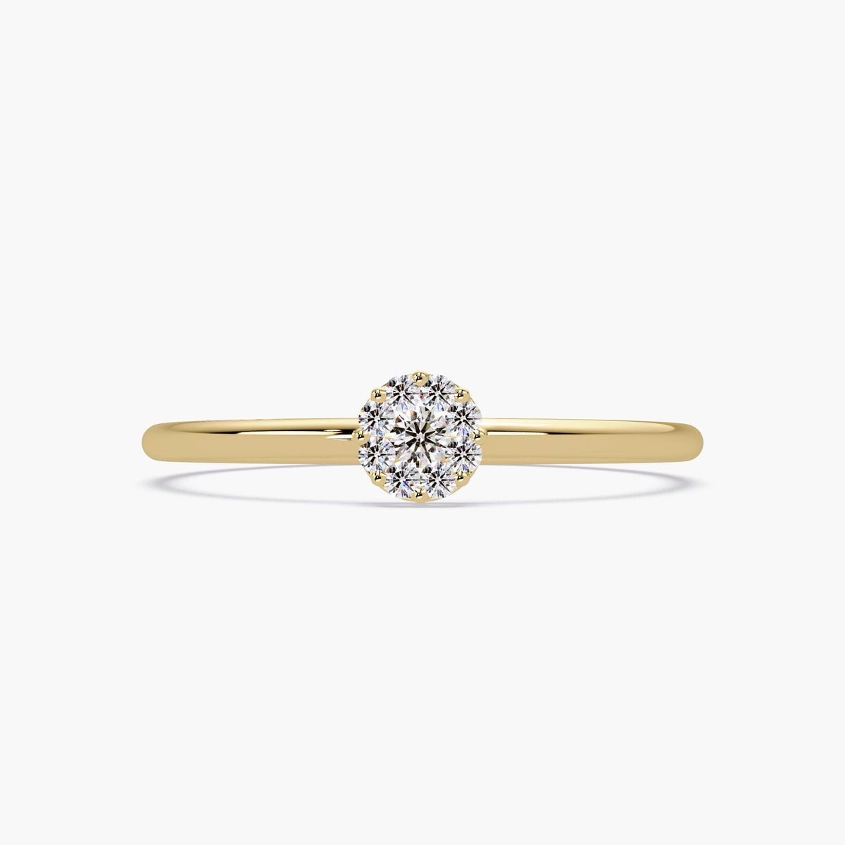 This is a dainty 14K yellow gold solitaire-style ring with a round diamond cluster centerpiece.