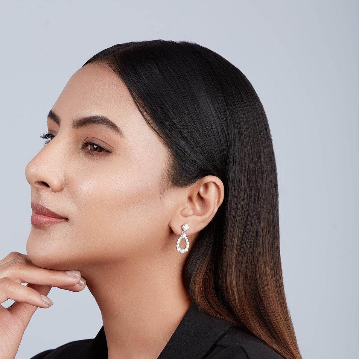 Model wearing teardrop diamond earrings showing elegant drop length