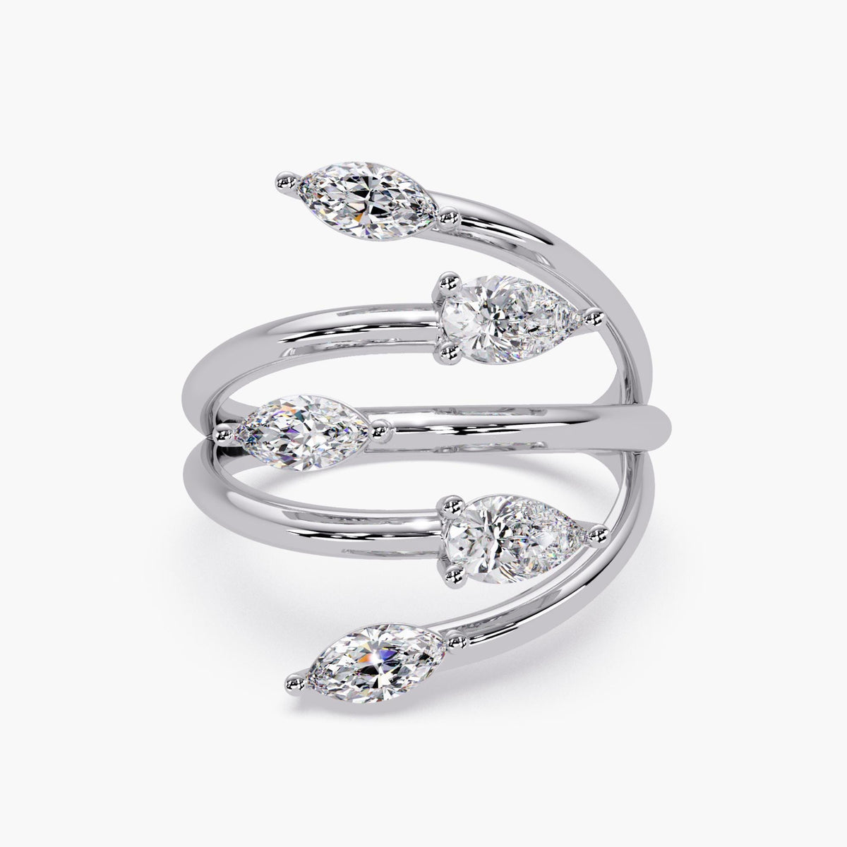 Close-up of marquise and pear diamond stones set in a polished white gold bypass design.