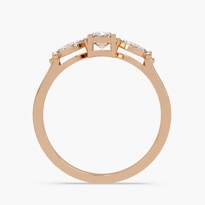 elegant dainty rose gold engagement ring with emerald and pear cuts