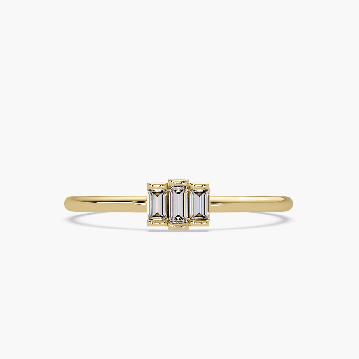 May include: A gold band ring with three small, rectangular, clear gemstones set in the center.