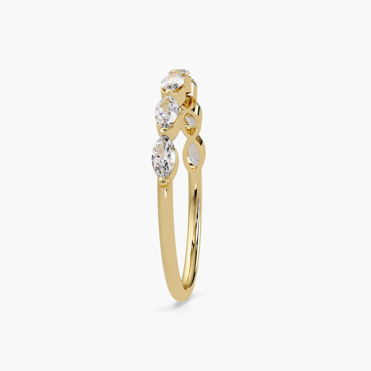 May include: A gold band ring with five marquise-shaped diamonds set in a row. The diamonds are clear and sparkly.