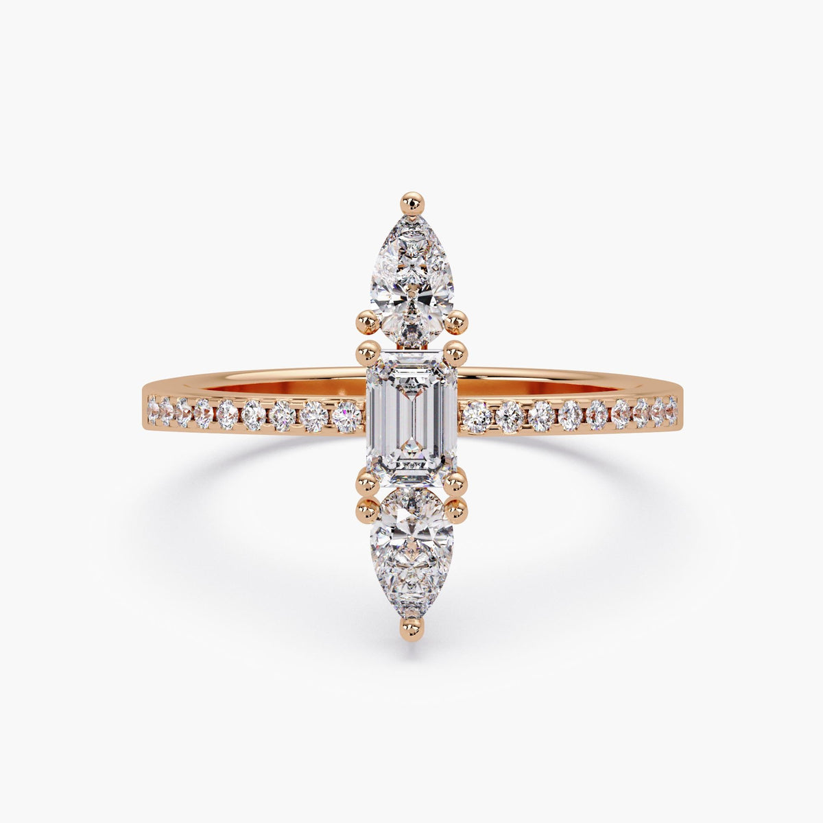 Rose gold lab diamond ring with emerald and pear stones, top view
