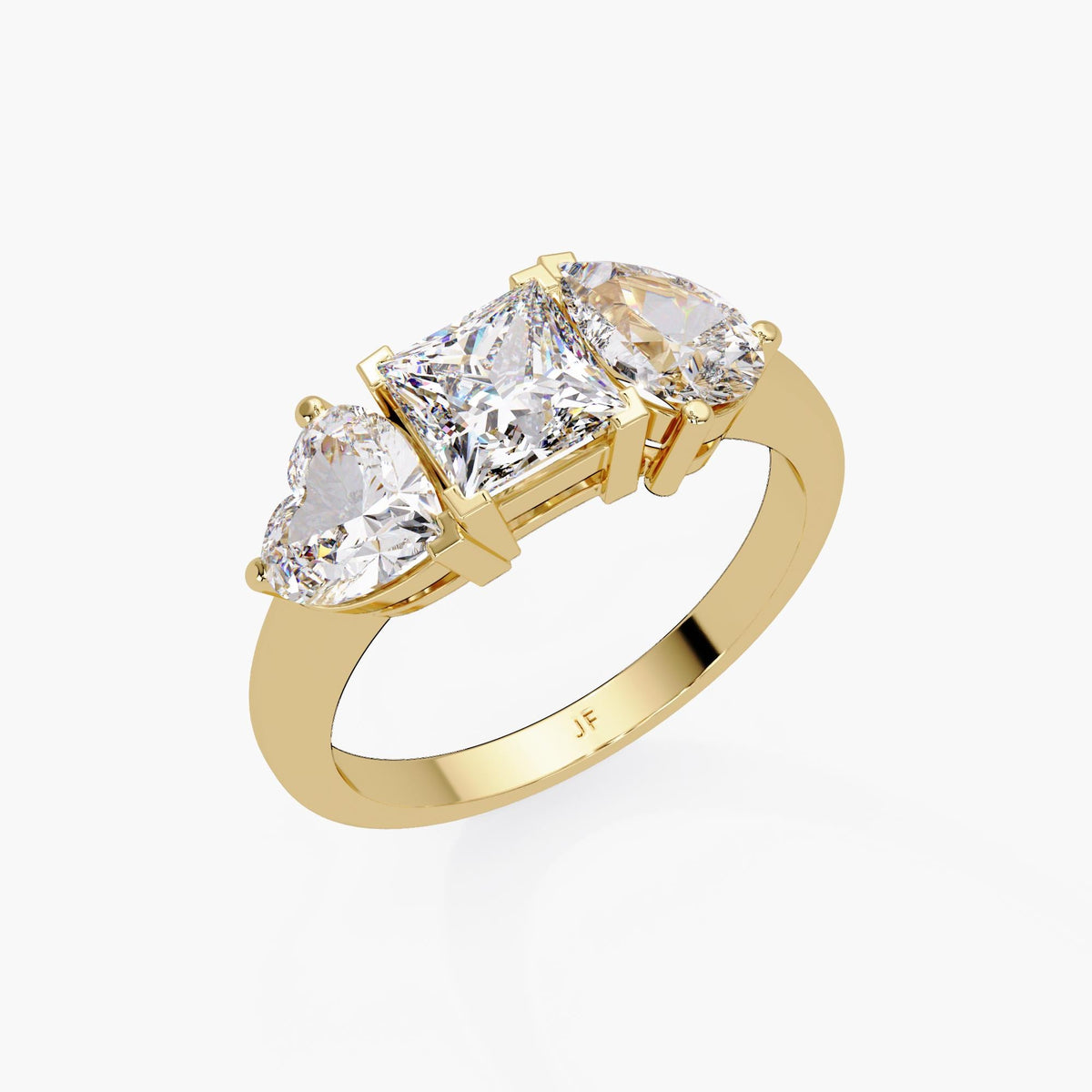 Three-stone engagement ring in 14K gold featuring princess, pear and heart-cut lab grown diamonds
