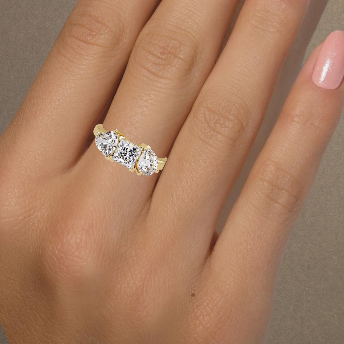 1 ct IGI certified princess diamond with heart and pear side stones in solid 14K gold setting