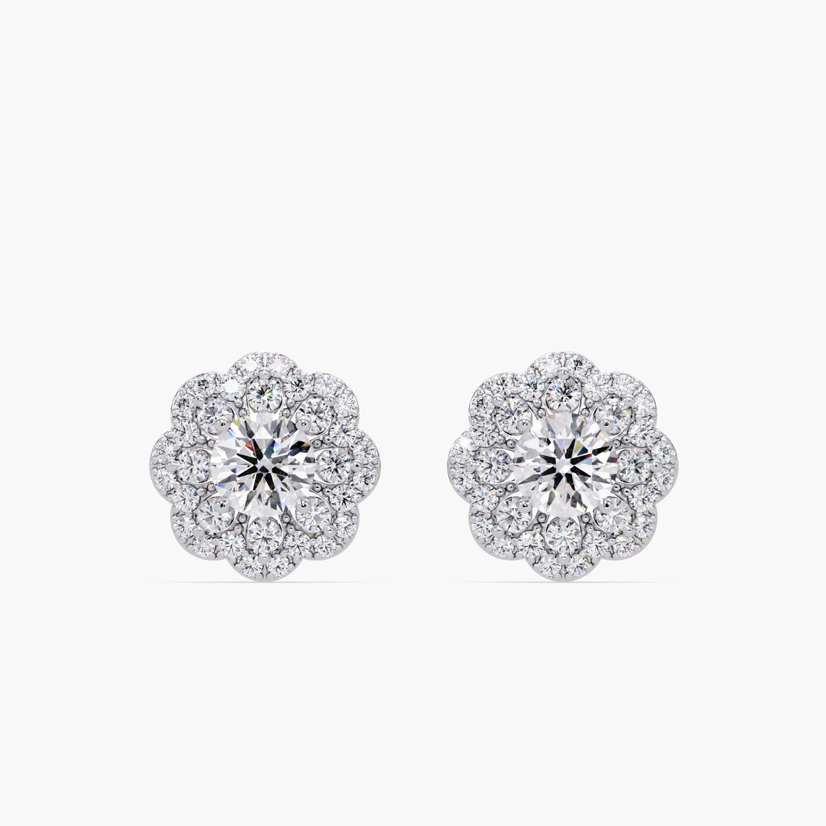 14K white gold diamond flower stud earrings with a cluster design featuring a center round diamond surrounded by smaller pavé diamonds