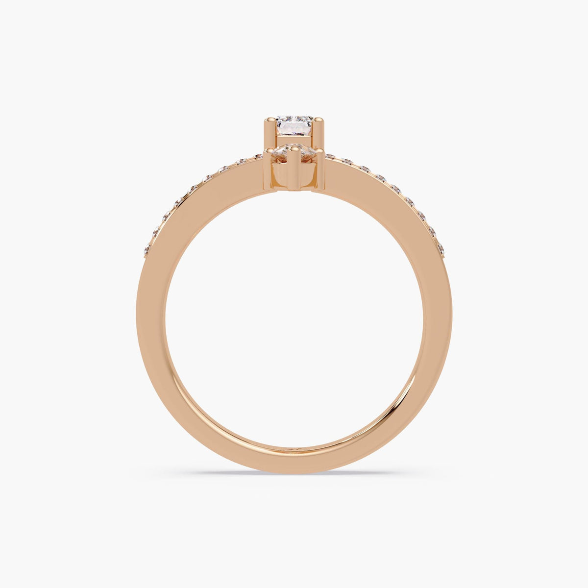 Rose gold lab diamond ring with emerald and pear stones, top view