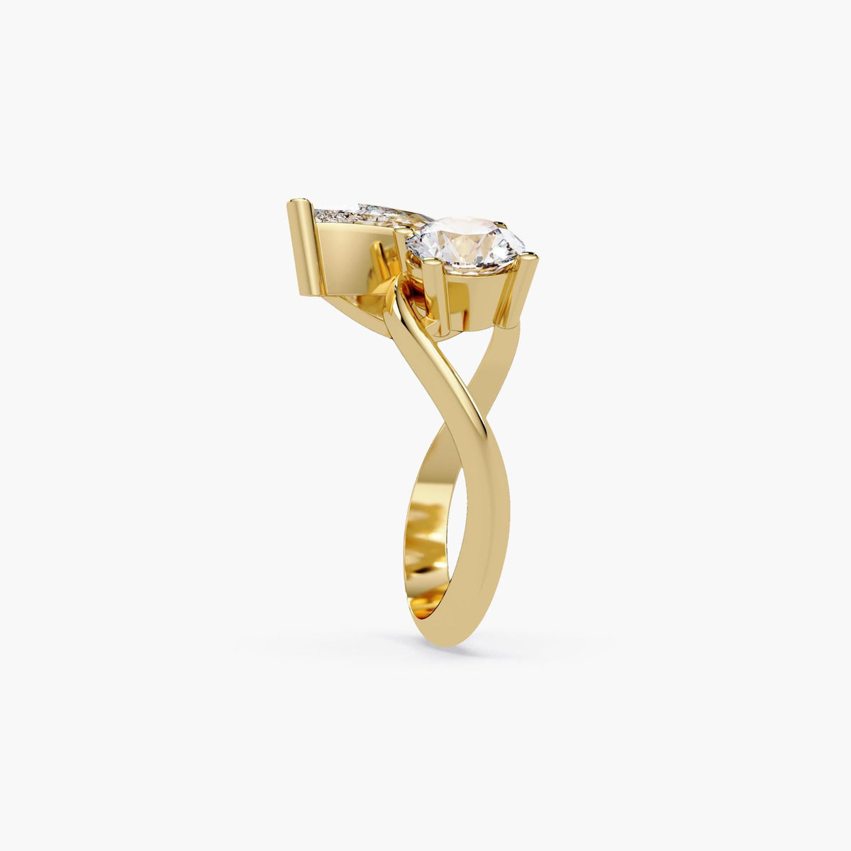 14k gold toi et moi ring with a pear diamond and round diamond in a bypass design.