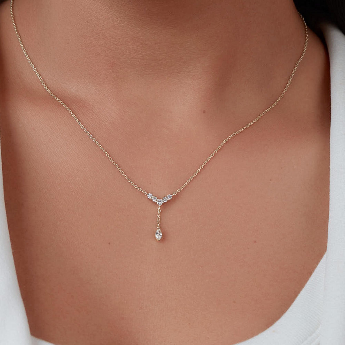 Close-up of a 14K gold marquise diamond Y lariat necklace resting at the collarbone.