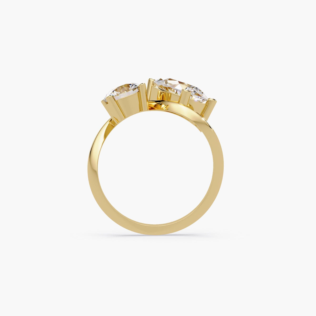 14k gold toi et moi ring with a pear diamond and round diamond in a bypass design.