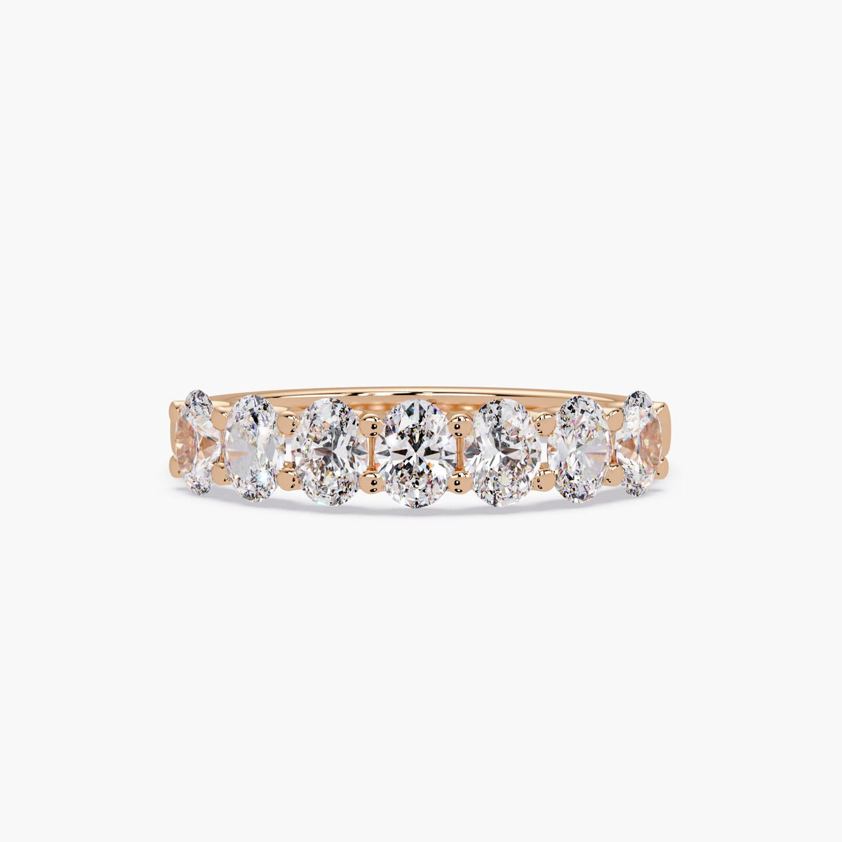 14K rose gold oval lab grown diamond band featuring seven prong-set oval diamonds arranged across the top of the ring.