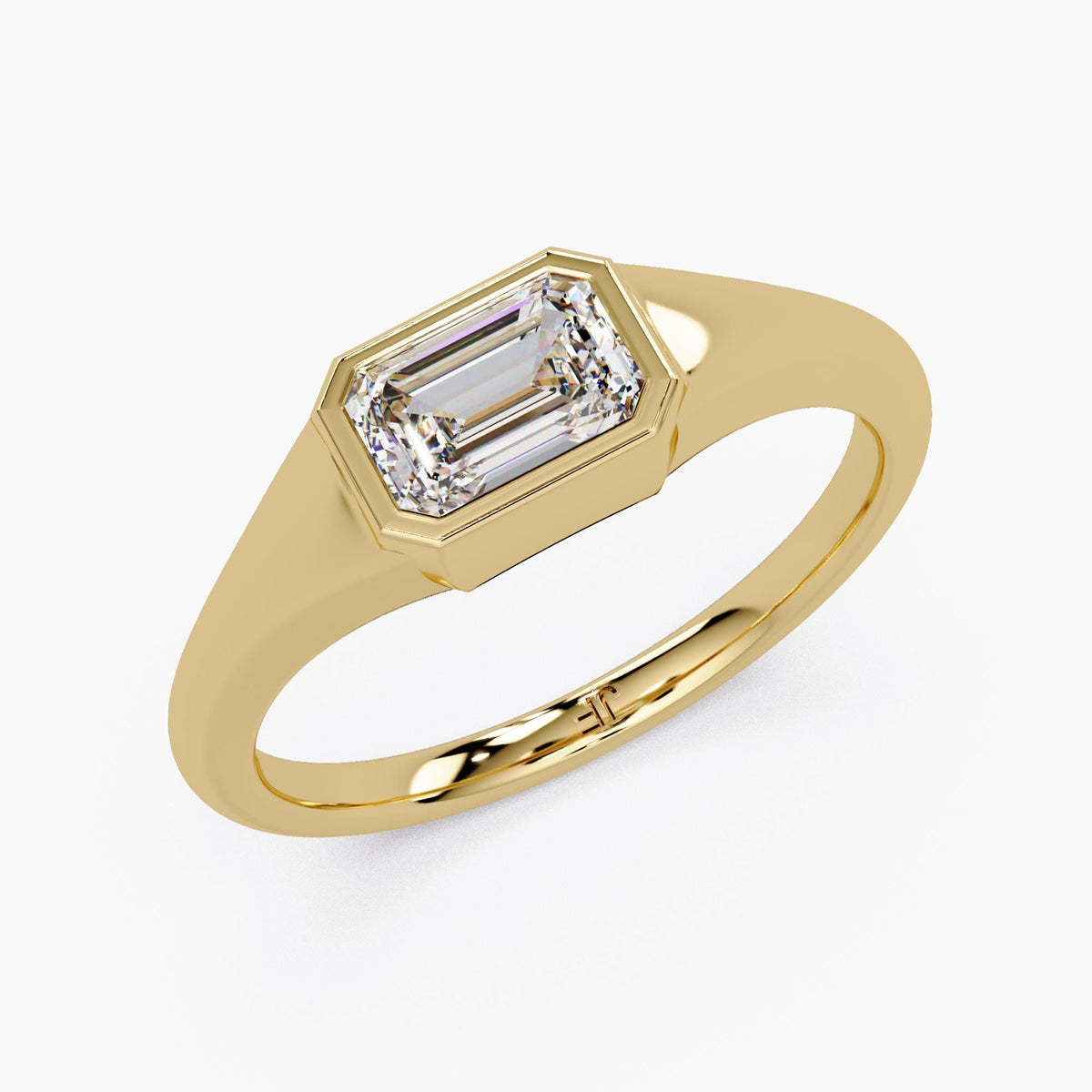 Emerald cut lab diamond signet ring in 14K yellow gold with a bezel-set center stone and smooth tapered band, styled as a modern pinky or statement ring for everyday wear.
