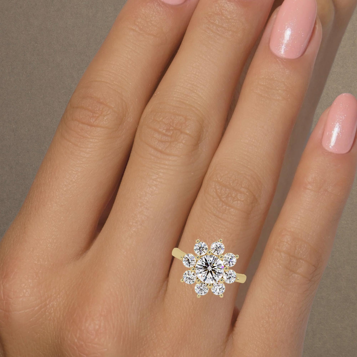 14K yellow gold floral halo ring. The 1.25CT center lab-grown diamond radiates brilliance, surrounded by eight shimmering accent stones that create a sunburst effect. This piece is designed to symbolize blooming love and timeless elegance for an engagement or special milestone.