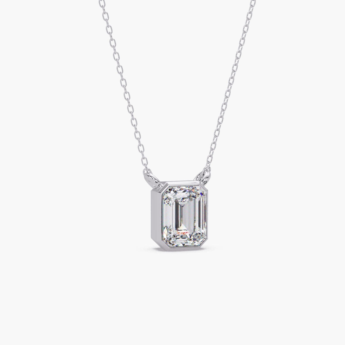14K white gold emerald cut lab grown diamond bezel pendant necklace with a polished rectangular setting and fine chain.