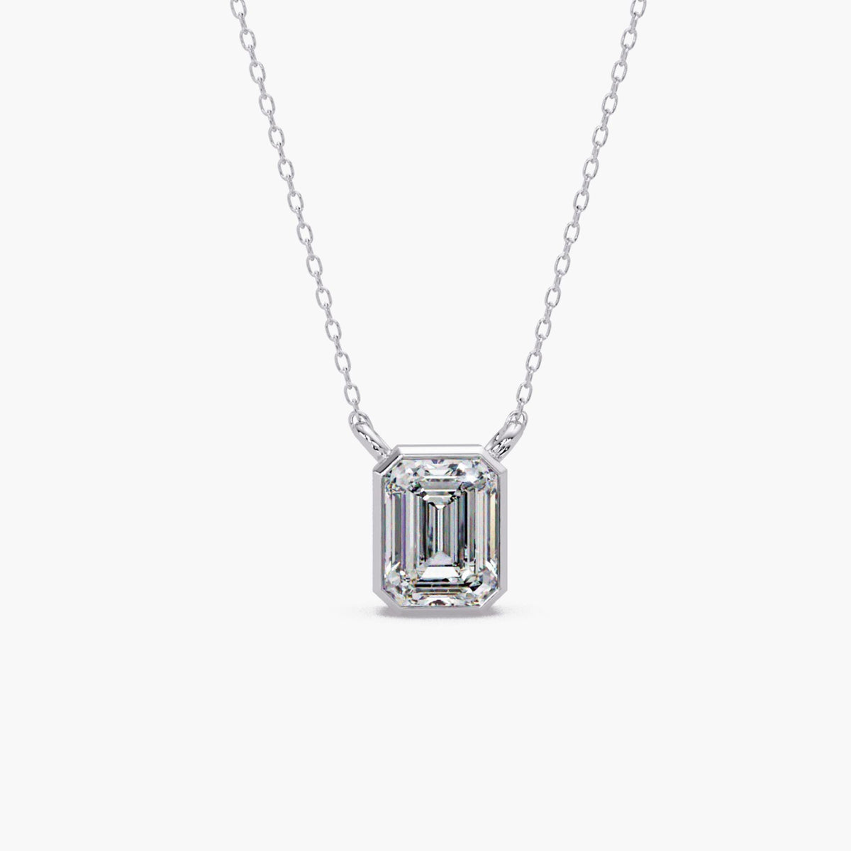 14K white gold emerald cut lab grown diamond bezel pendant necklace with a 1.5 carat IGI certified diamond on a fine cable chain.