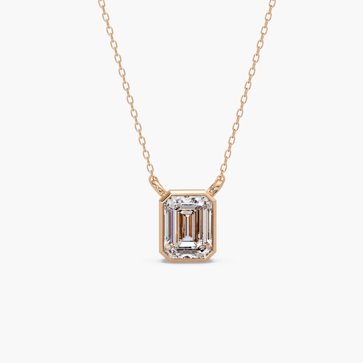 14K rose gold emerald cut lab grown diamond bezel pendant necklace, 1.5 carat IGI certified diamond on a fine gold cable chain.