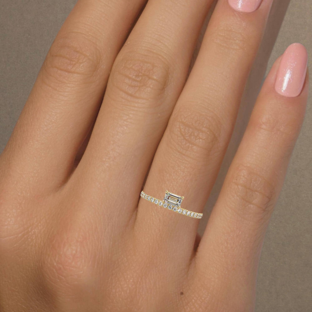 emerald cut east west diamond ring prong setting with pave band