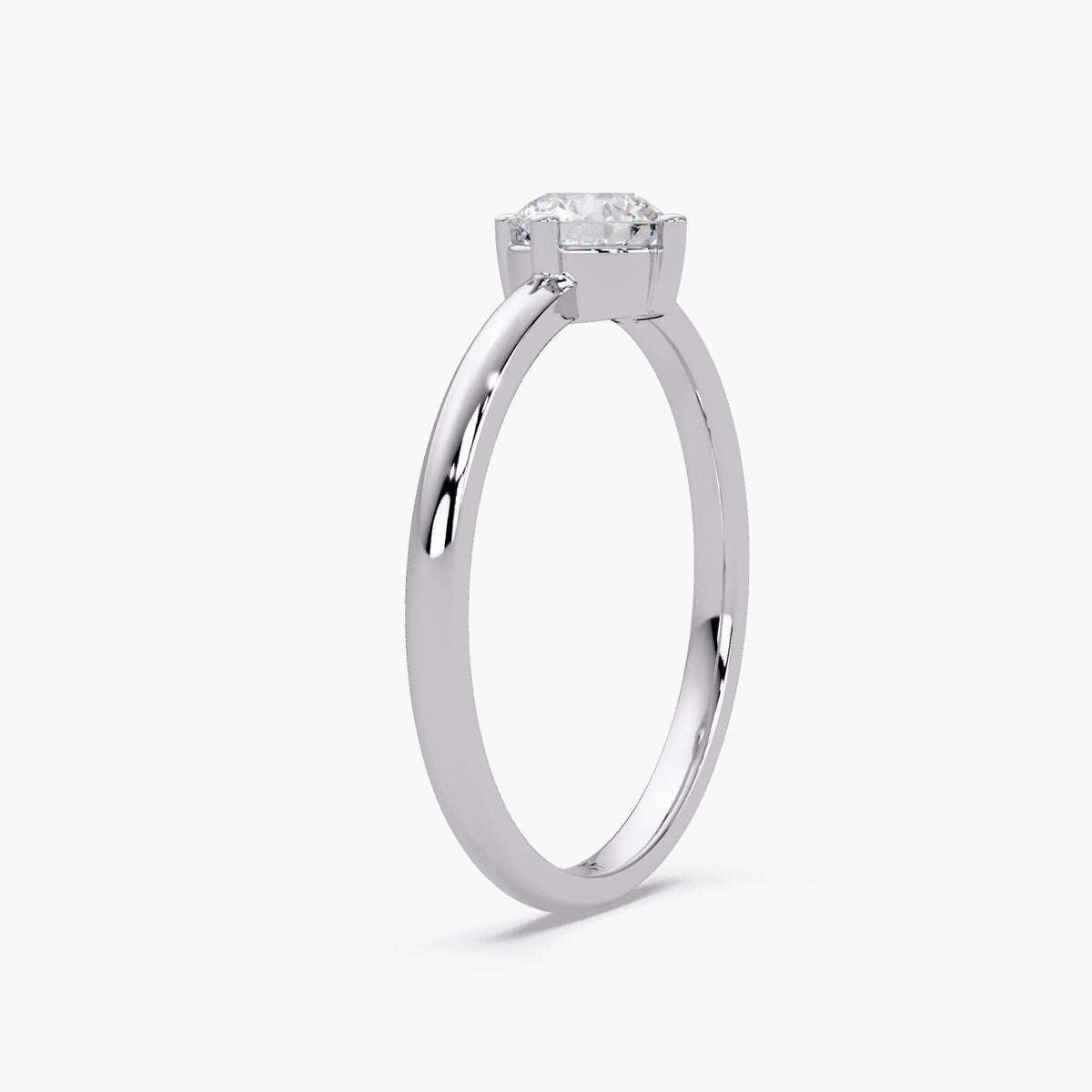 0.50 CT round lab grown diamond solitaire engagement ring in 14K white gold with four prong setting and thin 1.5mm band.