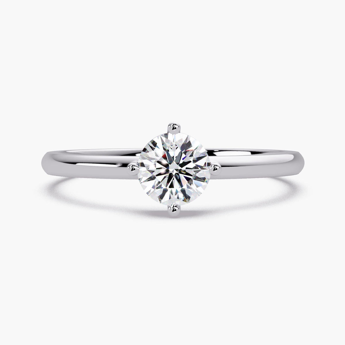 0.50 CT round lab grown diamond solitaire engagement ring in 14K white gold with four prong setting and thin 1.5mm band.