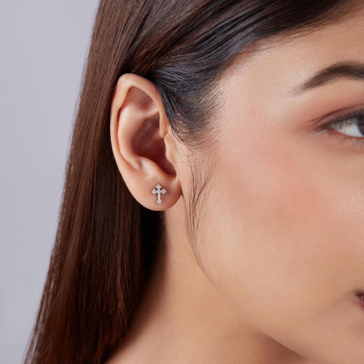 diamond cross stud earrings worn on ear, small lab grown diamond cross studs in 14k gold