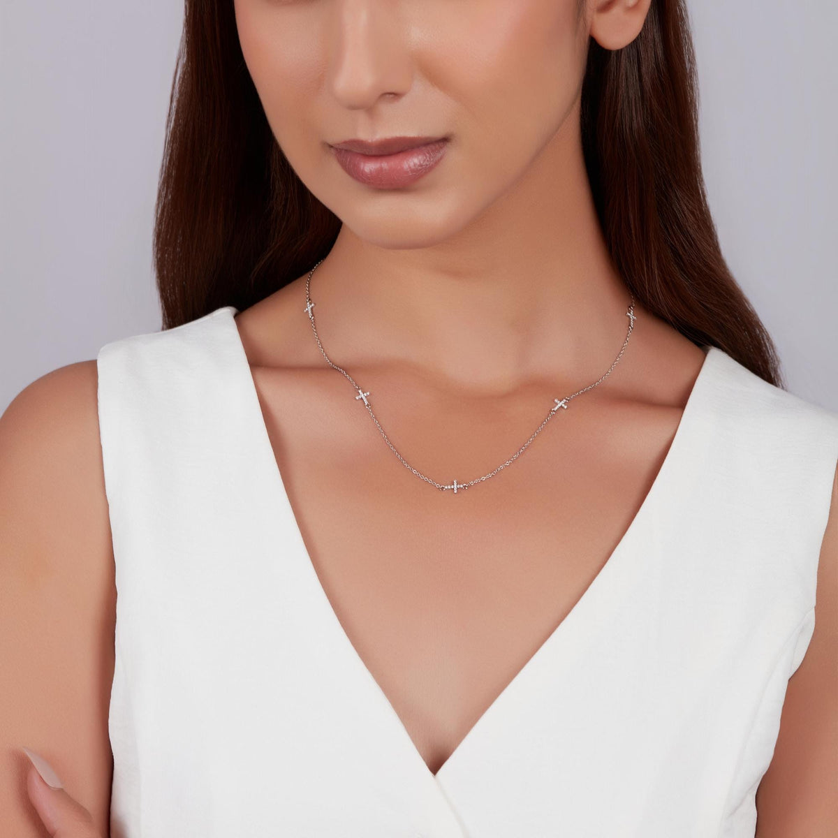Lab grown diamond cross station necklace worn on collarbone in 14K white gold, minimalist everyday jewelry