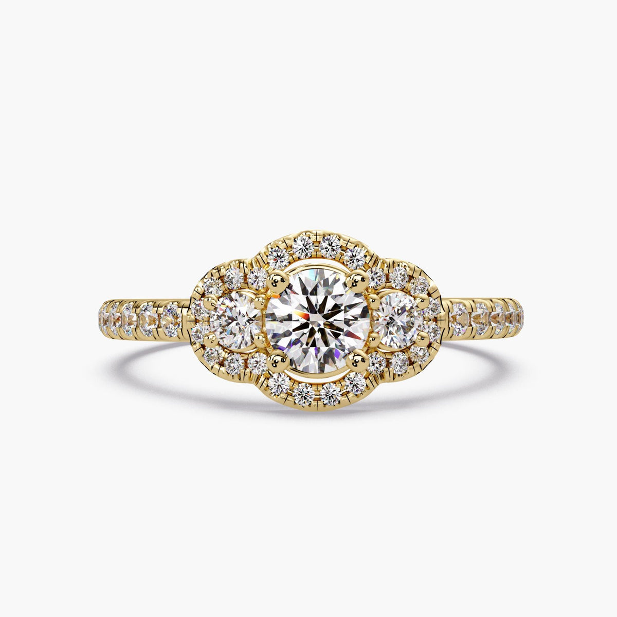 Round lab grown diamond trilogy halo engagement ring in 14K yellow gold featuring a 0.37 ct center diamond with two side diamonds and pavé halo detailing on a delicate band.