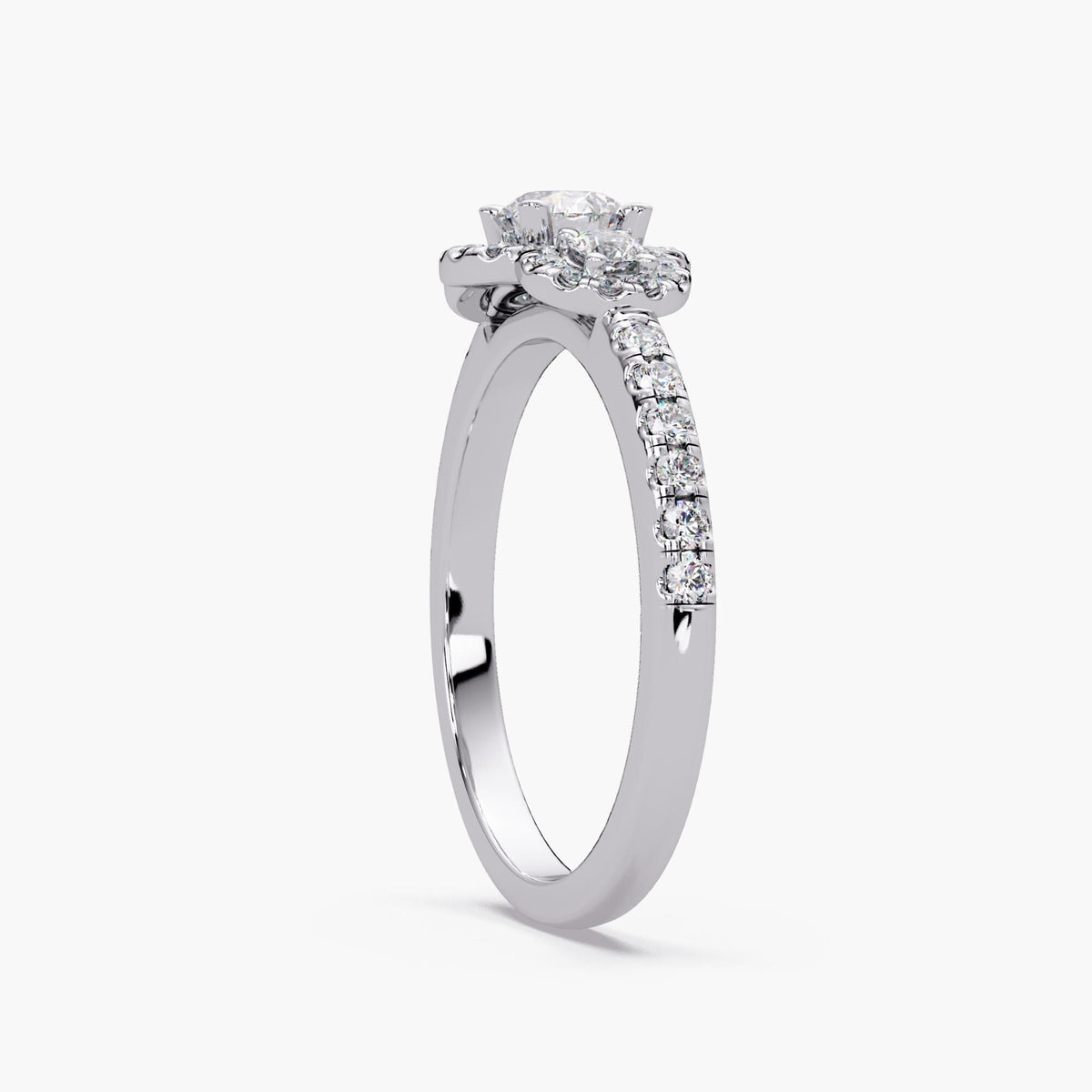 Round lab diamond three stone halo engagement ring in 14K white gold with pavé diamond band and vintage inspired cluster halo design.