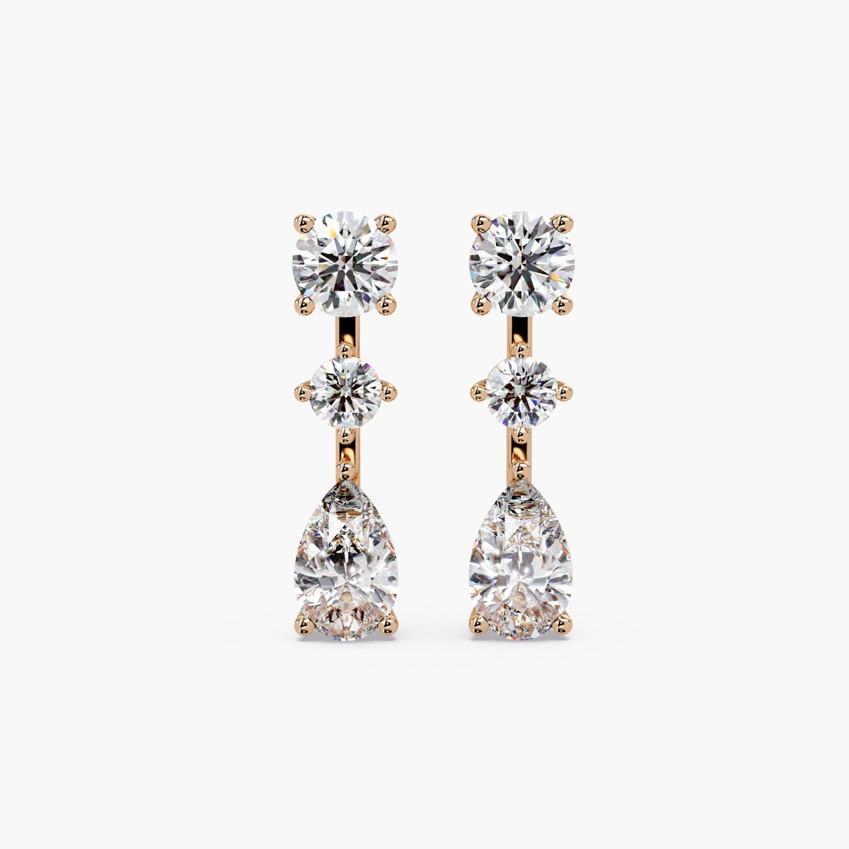 14K rose gold lab grown diamond drop earrings, featuring round stud top, center round diamond, and pear-shaped diamond drop in three-stone vertical design, 2.75 CTW
