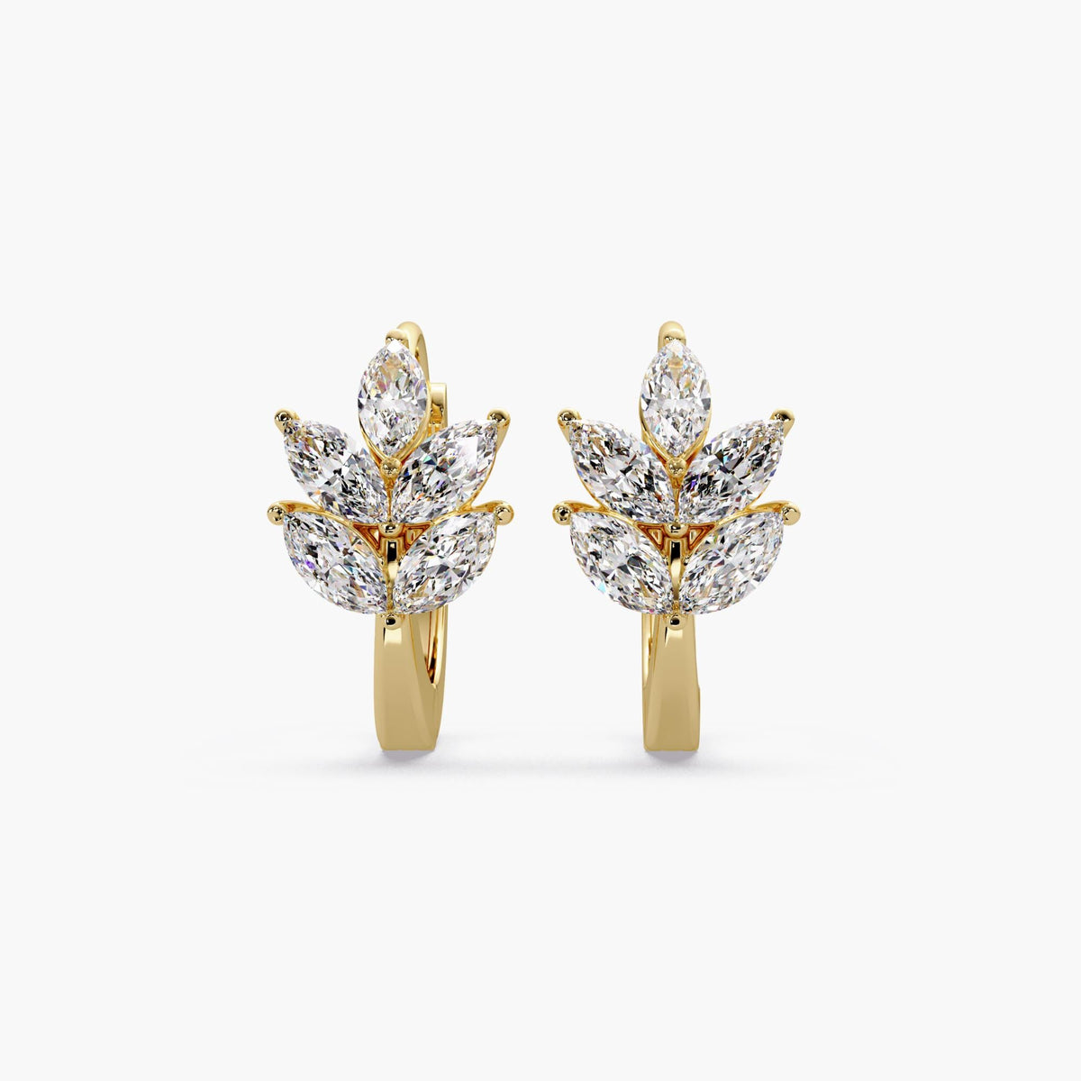 A pair of leaf huggie earrings crafted in solid 14K yellow gold, featuring marquise lab diamonds arranged in a leaf design cluster.