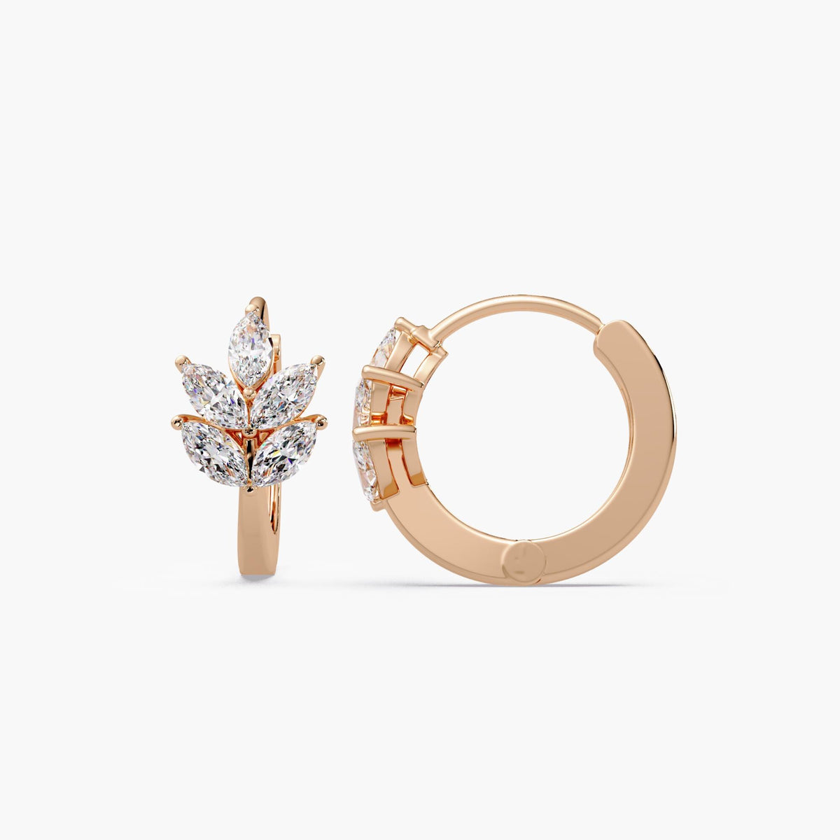 A pair of leaf huggie earrings crafted in solid 14K rose gold, featuring marquise lab diamonds arranged in a leaf design cluster.