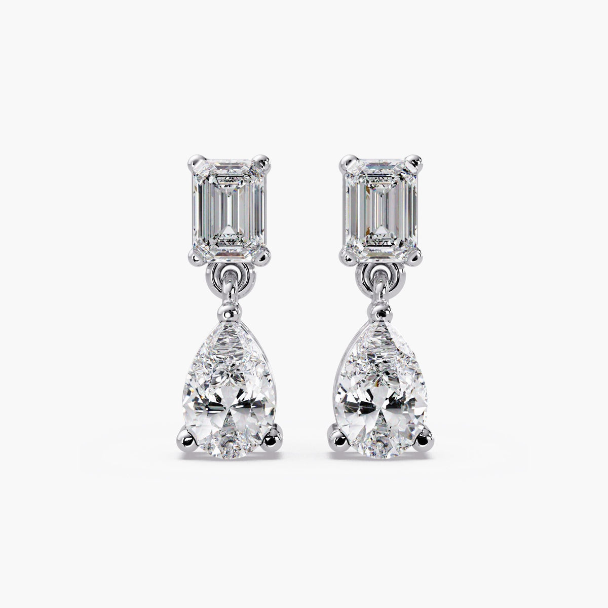 14K white gold diamond dangle earrings with emerald cut top and pear shaped drop design