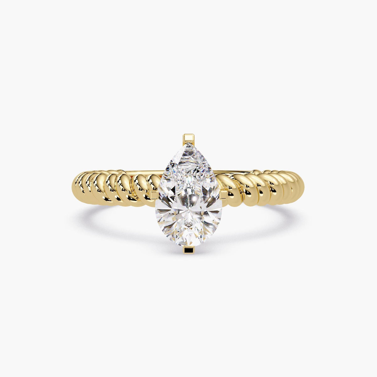 yellow gold ring featuring a large pear-shaped diamond solitaire on a thick rope band.