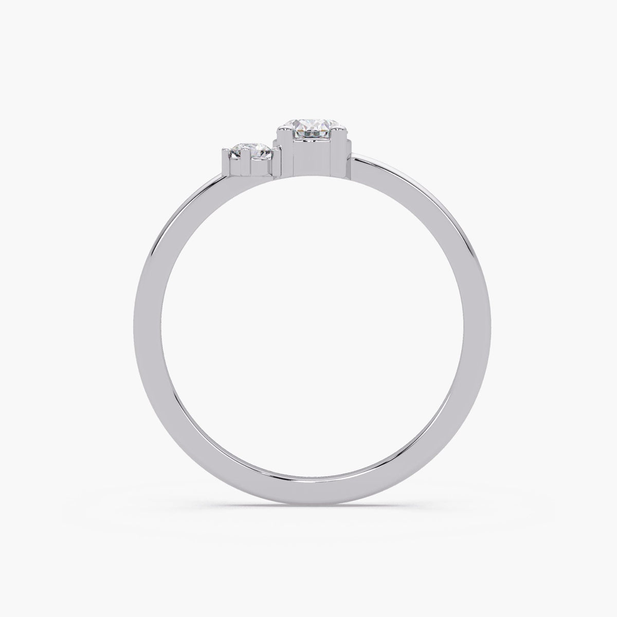 A silver ring with a central diamond and two smaller diamonds on either side.
