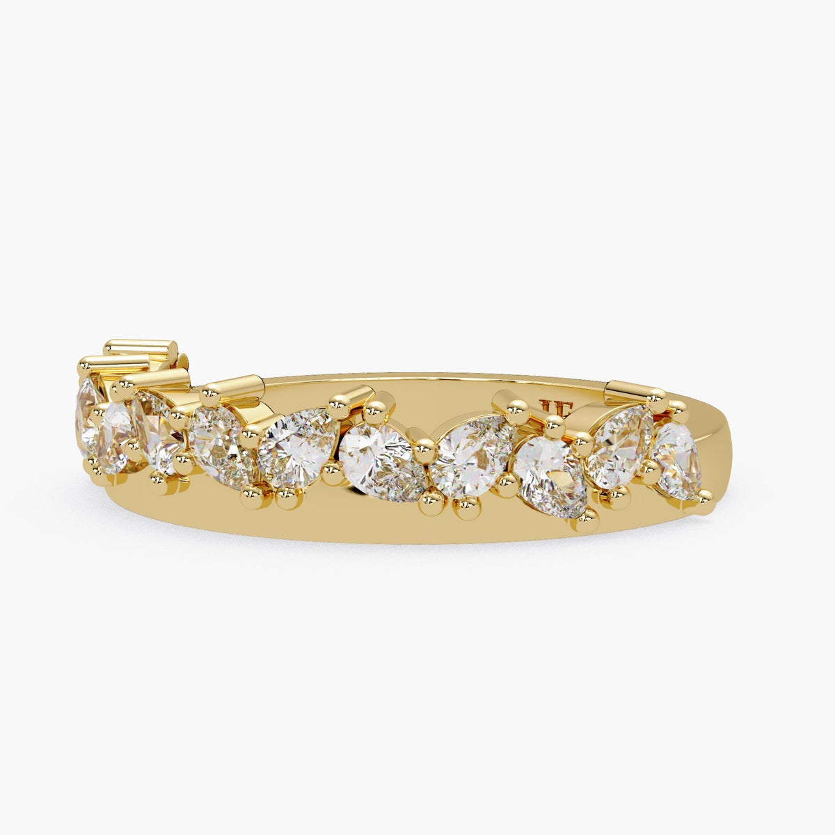 A gold ring with a row of diamond-encrusted pear-shaped stones.