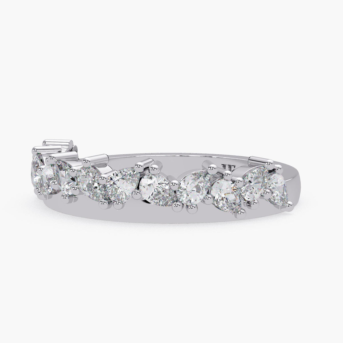 A silver ring with a row of large, clear diamonds set in a decorative pattern.