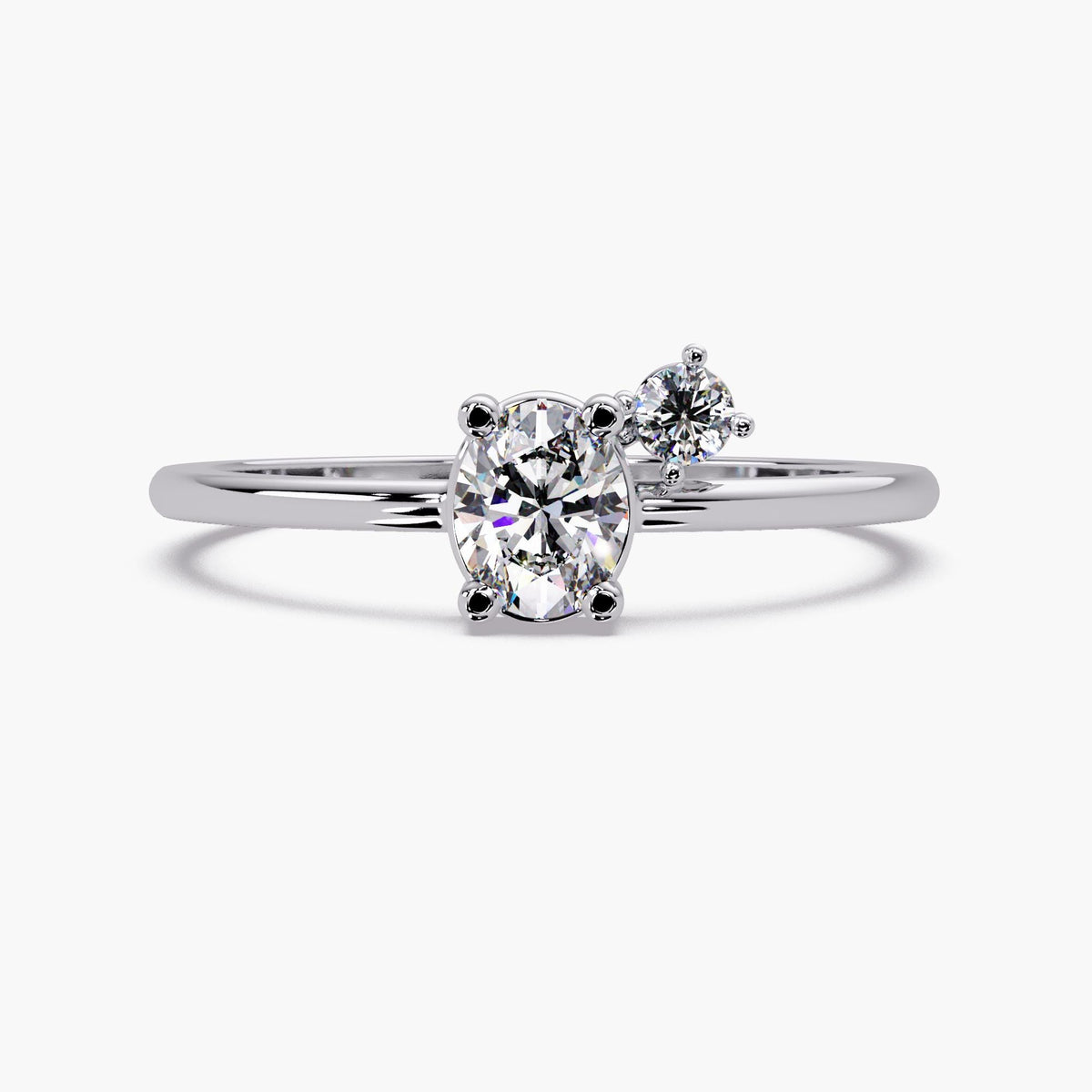 A silver ring with a large oval-shaped diamond in the center, surrounded by smaller diamonds.