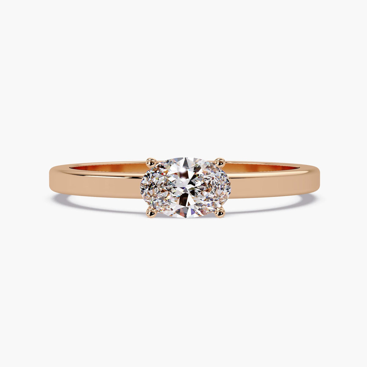 The oval lab-grown diamond solitaire ring in 14K rose gold with a slim polished band and four-prong setting.
