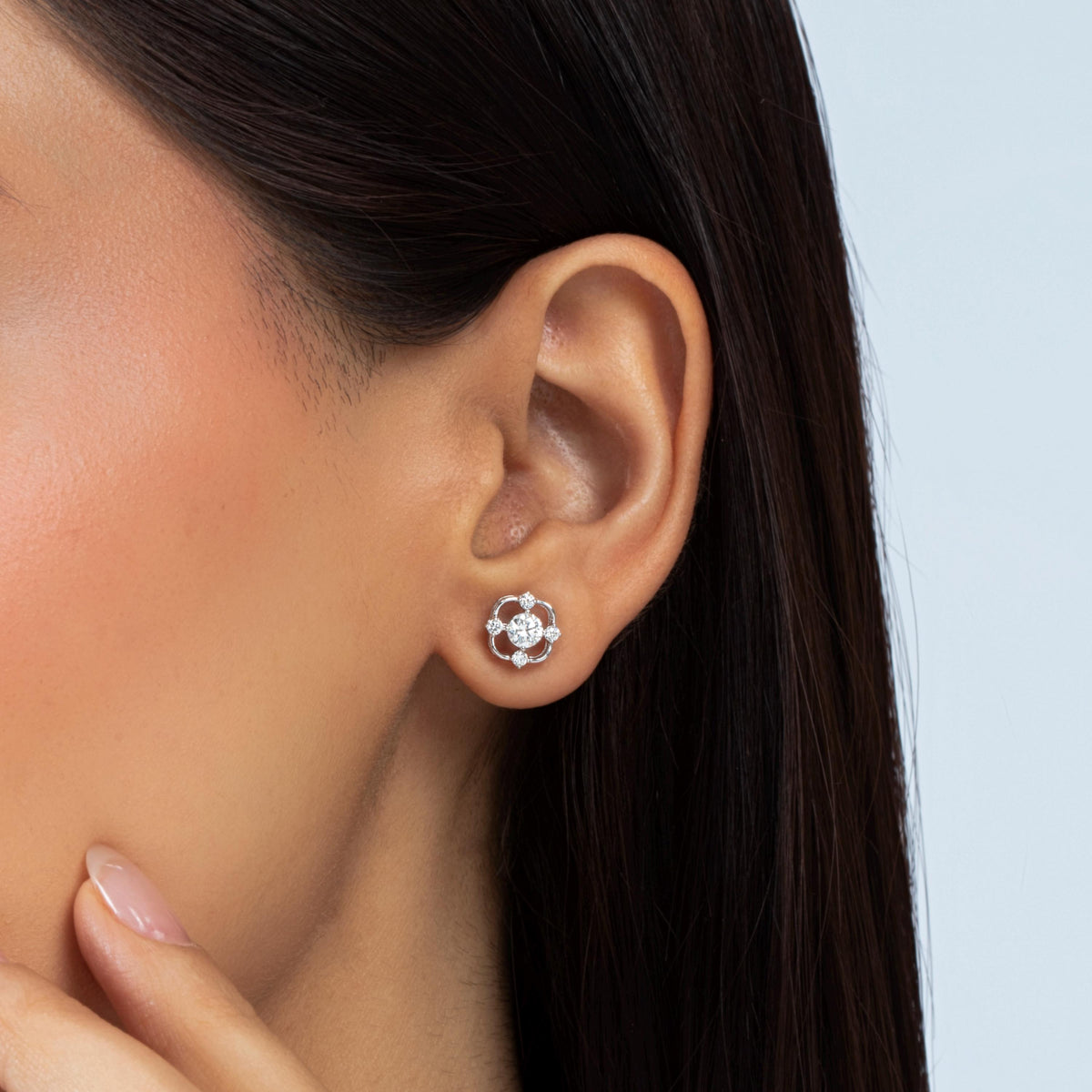 14K white gold lab-grown diamond stud earring with a round center diamond and four accent diamonds in an open floral setting.
